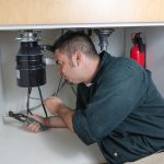 Pirates Plumbing Plumber fixing a garbage disposal in Palm Harbor Florida