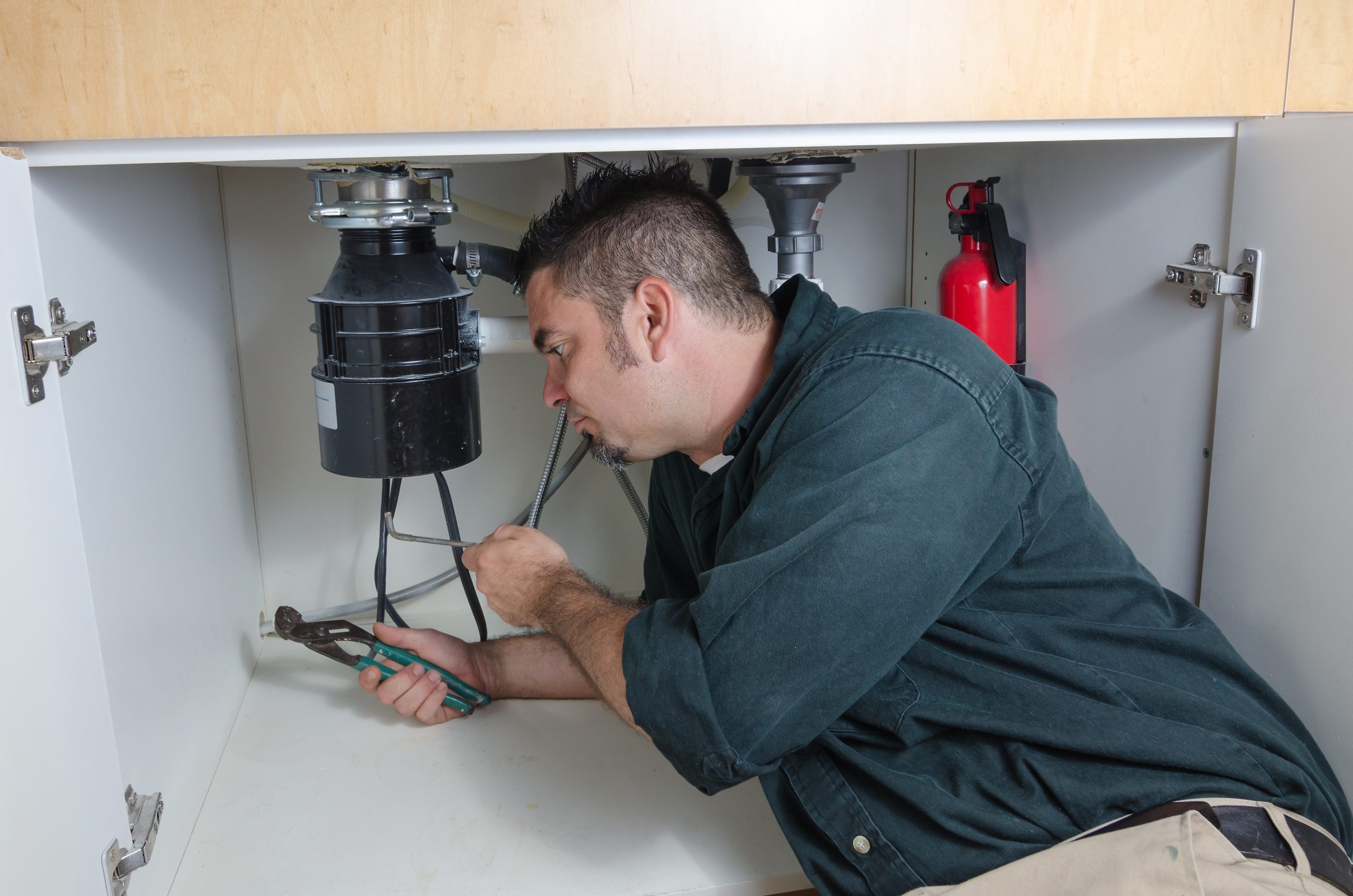 Pirates Plumbing Plumber fixing a garbage disposal in Palm Harbor Florida