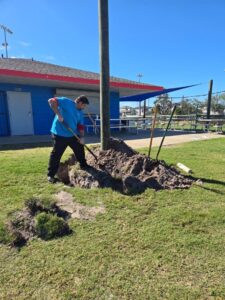 Plumber digging trench for sewer line repair in Trinity FL