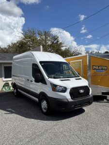Plumber service van and Pirates Plumbing trailer in East Lake FL